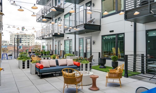 Large courtyard deck with plenty of seating and a view of the city 